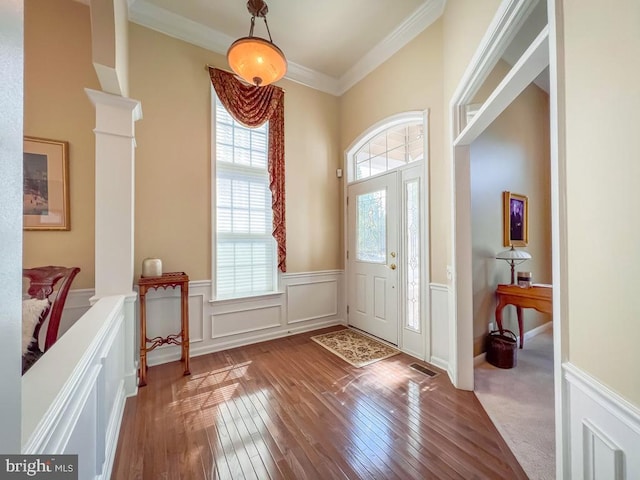 entrance foyer featuring hardwood / wood-style floors and crown molding