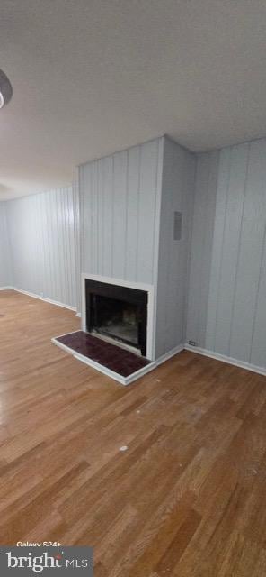 unfurnished living room with a textured ceiling and hardwood / wood-style floors