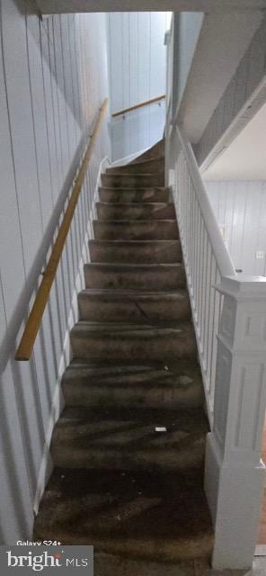 stairway featuring hardwood / wood-style floors