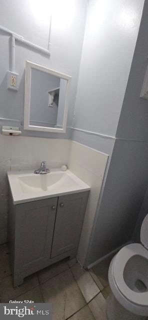 bathroom featuring vanity, toilet, and tile patterned flooring