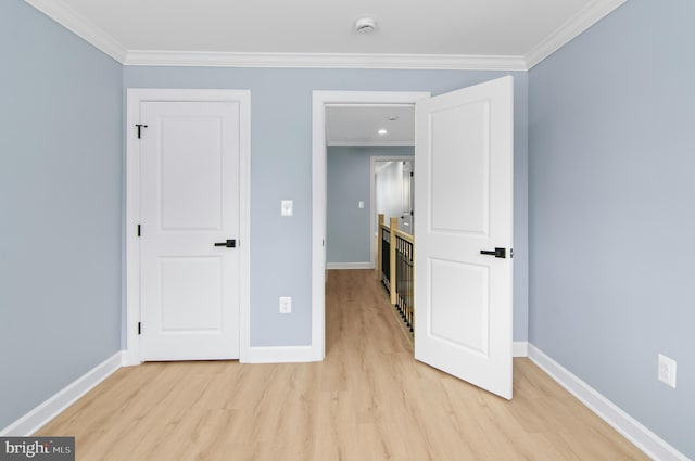 unfurnished room featuring light wood-type flooring and ornamental molding