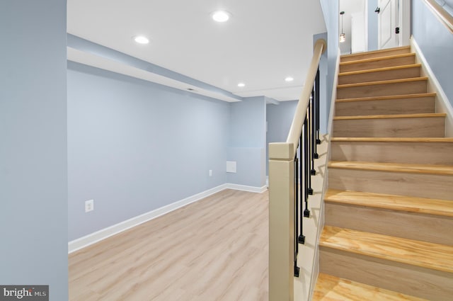 staircase featuring hardwood / wood-style flooring