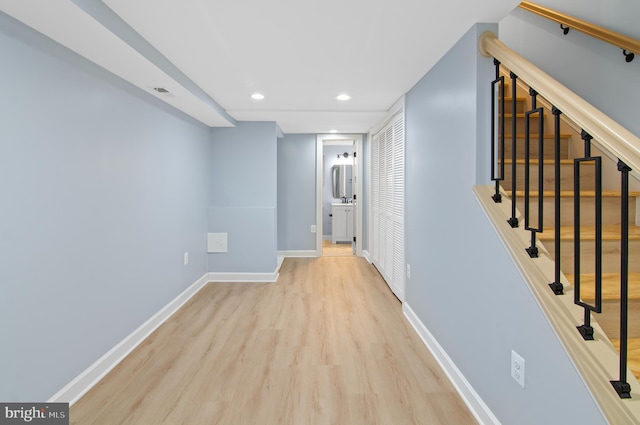 hallway with light hardwood / wood-style flooring