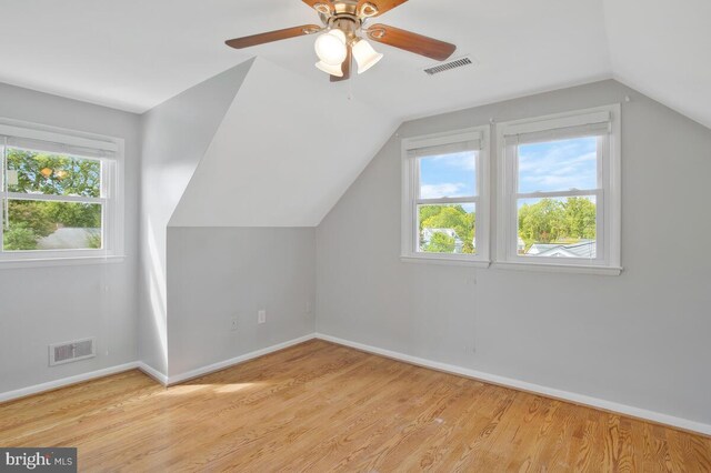 additional living space with lofted ceiling, a wealth of natural light, ceiling fan, and light hardwood / wood-style floors