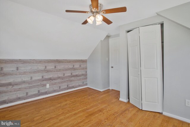 bonus room featuring ceiling fan, light hardwood / wood-style floors, and vaulted ceiling