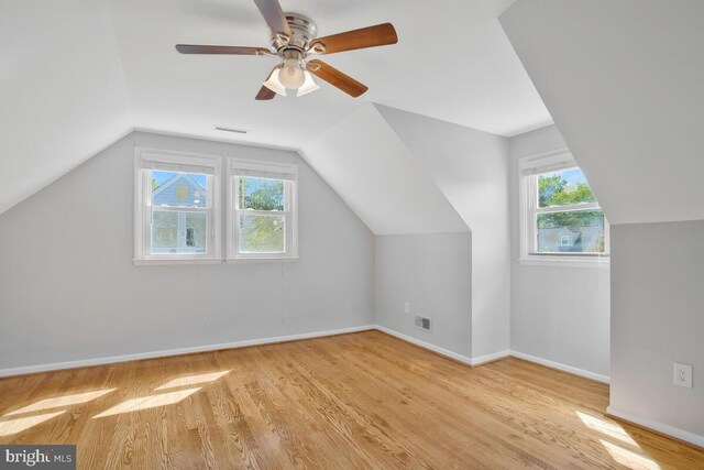 bonus room with light wood-type flooring, lofted ceiling, and ceiling fan