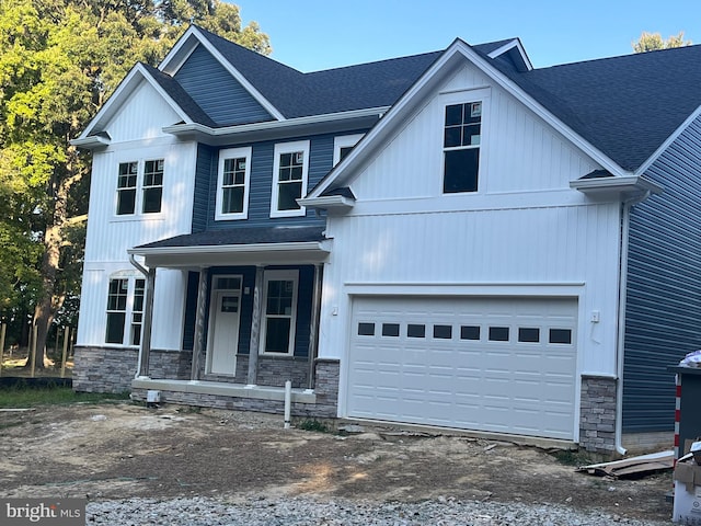 view of front facade featuring a porch and a garage