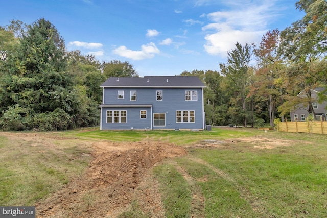 rear view of house featuring a lawn