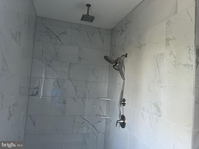 interior details featuring tiled shower