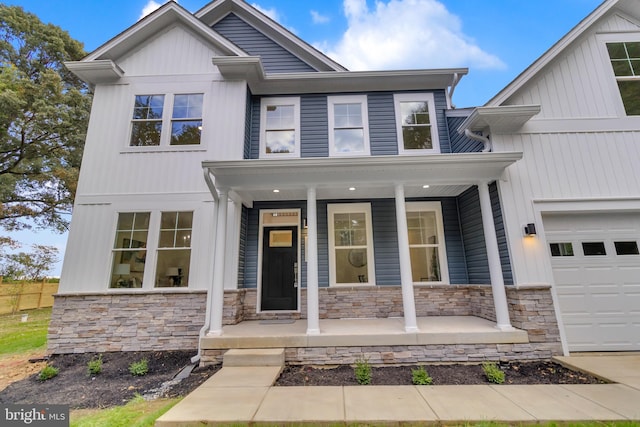 view of front of house with a porch and a garage