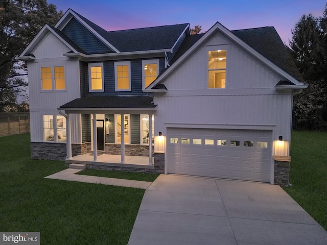 view of front of property with a yard and a garage