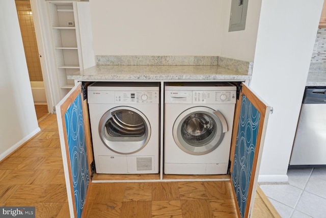 laundry area with washer and dryer, electric panel, and light tile patterned floors