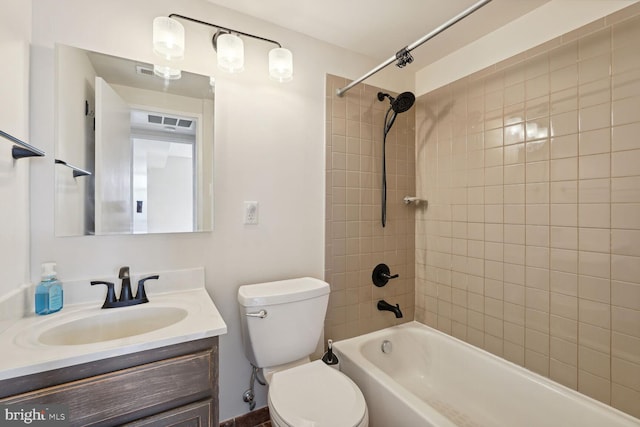 full bathroom with toilet, tiled shower / bath, and vanity