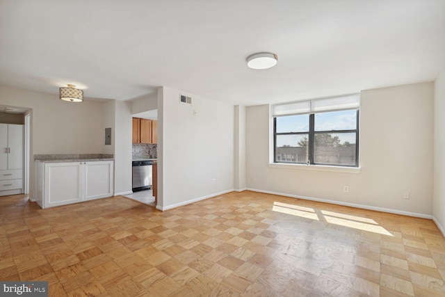 unfurnished living room featuring electric panel and light parquet flooring