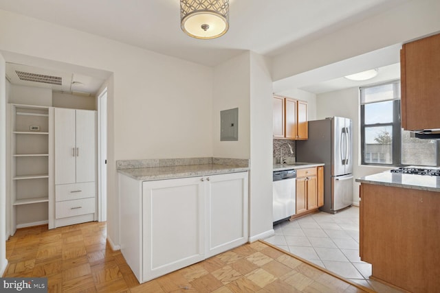 kitchen featuring tasteful backsplash, sink, light parquet floors, stainless steel appliances, and electric panel