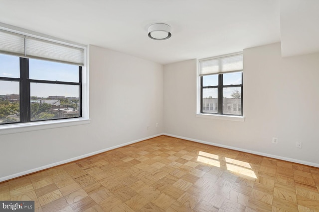 empty room featuring light parquet flooring and plenty of natural light