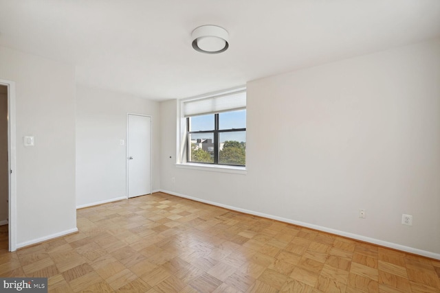 unfurnished room with light parquet flooring