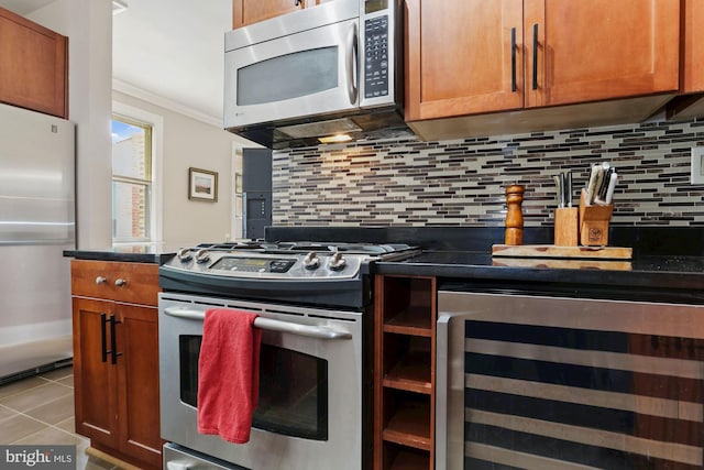 kitchen featuring ornamental molding, stainless steel appliances, beverage cooler, and decorative backsplash