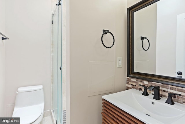 bathroom featuring vanity, toilet, an enclosed shower, and decorative backsplash