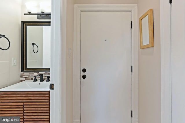 bathroom featuring vanity and decorative backsplash