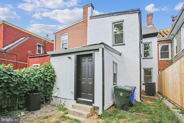 rear view of property with central AC