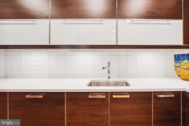 kitchen featuring dark brown cabinetry and sink