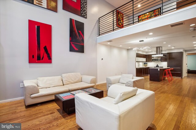 living room featuring hardwood / wood-style flooring and a high ceiling