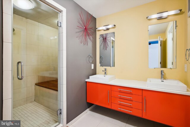 bathroom featuring vanity, an enclosed shower, and tile patterned floors