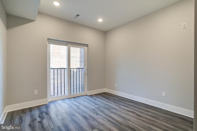 spare room with dark wood-type flooring