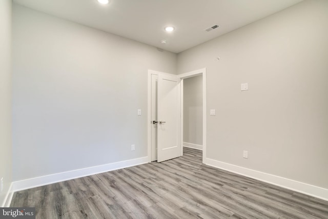 empty room with light hardwood / wood-style flooring