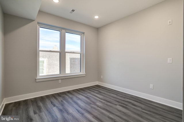 spare room with dark hardwood / wood-style floors