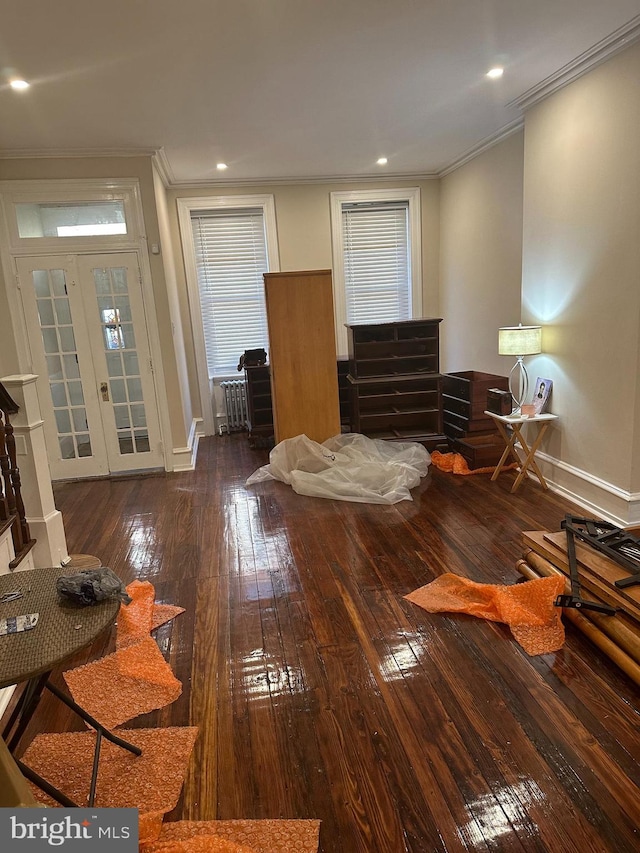 living room featuring crown molding, dark wood-type flooring, radiator heating unit, and french doors