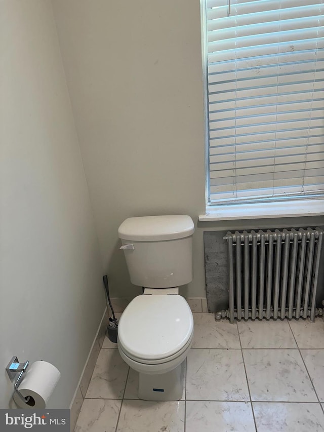 bathroom featuring toilet and radiator heating unit