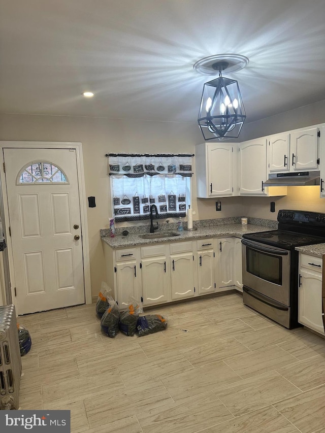 kitchen featuring sink, a chandelier, dark stone countertops, white cabinets, and stainless steel range with electric cooktop