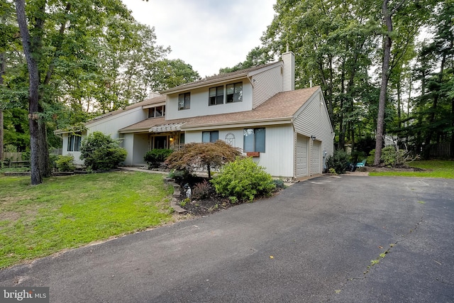 view of front facade with a front yard and a garage