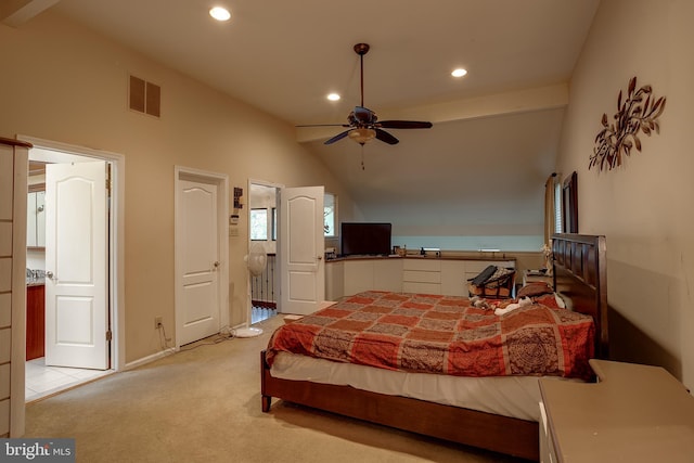 carpeted bedroom with ensuite bath, vaulted ceiling, and ceiling fan