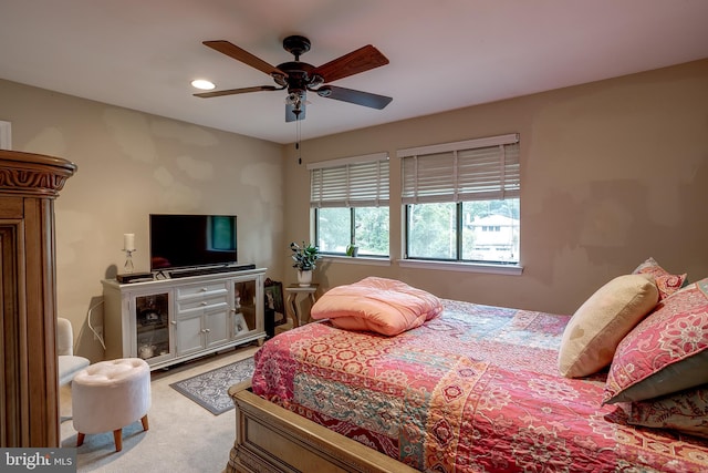 bedroom featuring ceiling fan and carpet