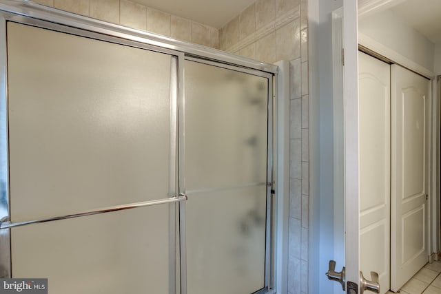 bathroom with tile patterned floors and a shower with shower door