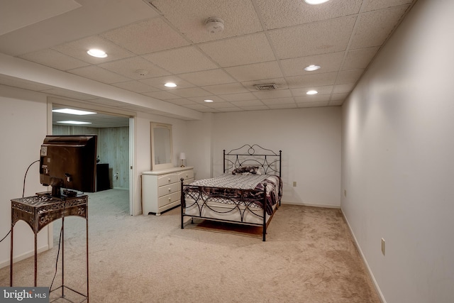 carpeted bedroom with a drop ceiling