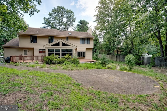 rear view of property featuring a deck