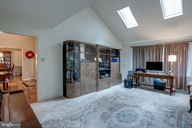 living room with hardwood / wood-style flooring, high vaulted ceiling, and a skylight