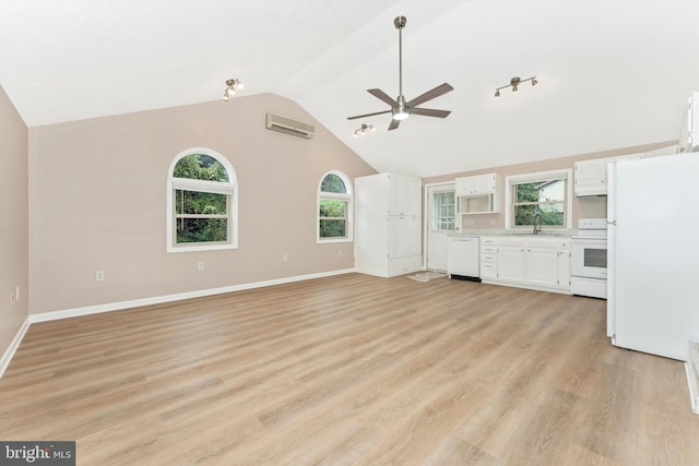 unfurnished living room with ceiling fan, light hardwood / wood-style flooring, plenty of natural light, and an AC wall unit