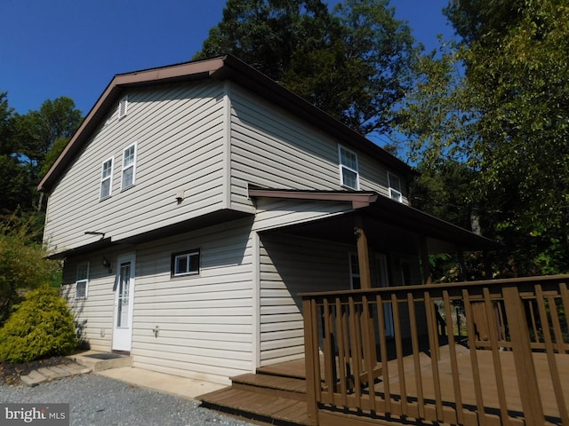 view of side of home featuring a wooden deck