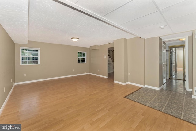 empty room with hardwood / wood-style floors and a wealth of natural light