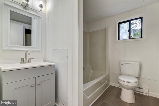 full bathroom featuring hardwood / wood-style floors, vanity, shower / tub combination, a baseboard heating unit, and toilet