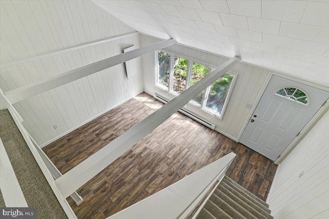 foyer with dark hardwood / wood-style flooring, wooden walls, and lofted ceiling