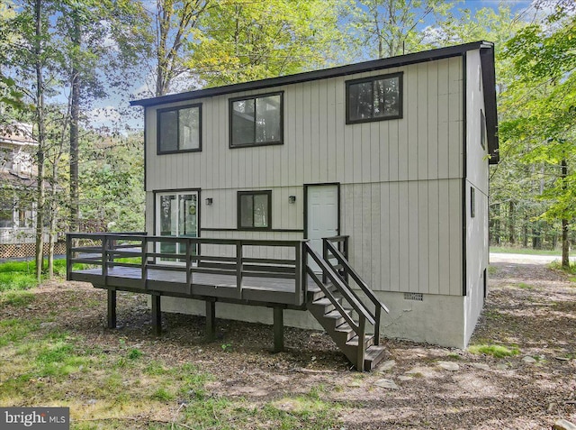 rear view of house featuring a deck