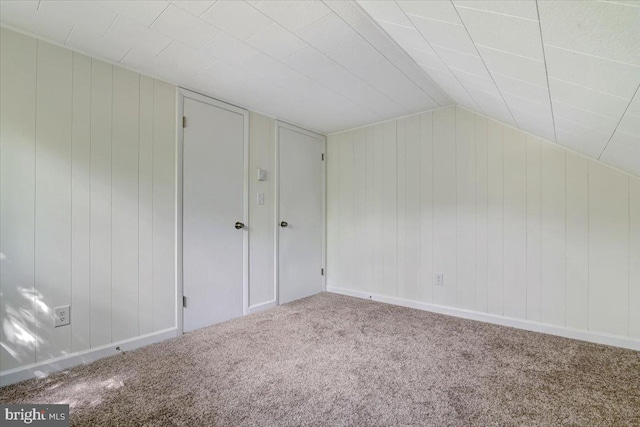 bonus room featuring carpet floors and vaulted ceiling