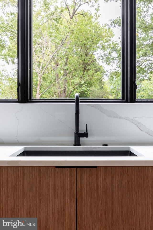 room details with light stone counters and sink