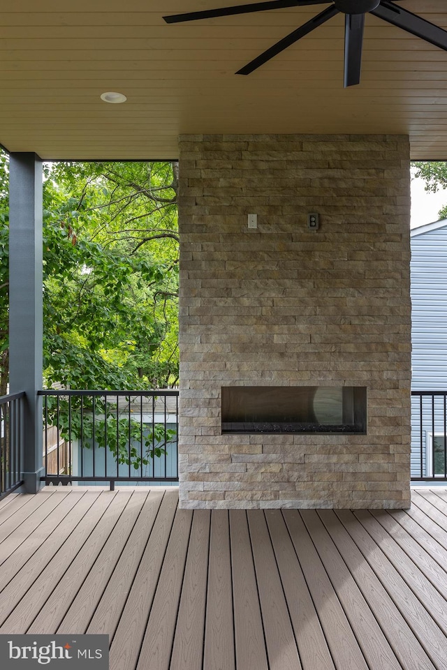 wooden deck featuring ceiling fan